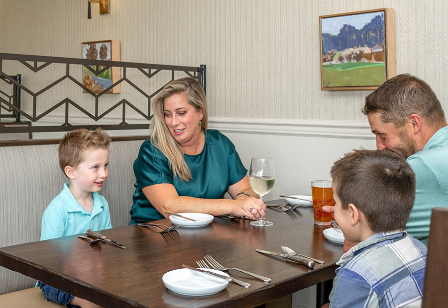 family seated at a booth style table