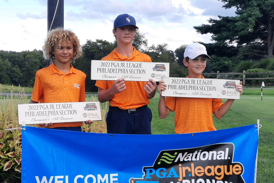 young golfers displaying awards